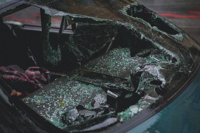 green car with a smashed screen