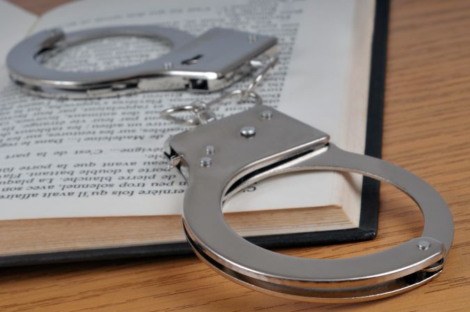 Handcuffs lying on top of an open book